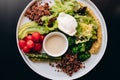 A healthy bowl of quinoa, poached egg, asparagus, tomatoes, chickpeas and avocado. Restaurant service Royalty Free Stock Photo