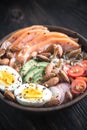 Healthy bowl with salmon, avocado, egg and vegs Royalty Free Stock Photo