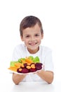 Healthy boy with fresh vegetables on plate Royalty Free Stock Photo