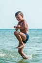 Healthy boy jumping in water Royalty Free Stock Photo
