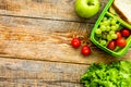 Healthy break with apple, grape and sandwich in lunchbox on home table flat lay mock-up Royalty Free Stock Photo