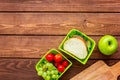 Healthy break with apple, grape and sandwich in lunchbox on home table flat lay mock-up Royalty Free Stock Photo