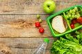 Healthy break with apple, grape and sandwich in lunchbox on home table flat lay mock-up Royalty Free Stock Photo