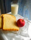 Healthy breakfast apple glass of milk and bread morning