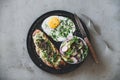 Healthy breakfast with avocado toast, fried egg and green salad Royalty Free Stock Photo