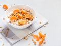 Healthy breakfast. Baked muesli with tropical fruits, fresh tangerines and yogurt on white background Royalty Free Stock Photo