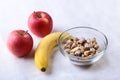 Healthy breakfast with banana, apple and Fresh granola, muesli in bowl on textile background. Top view. Royalty Free Stock Photo