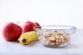 Healthy breakfast with banana, apple and Fresh granola, muesli in bowl on textile background. Top view. Royalty Free Stock Photo