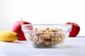 Healthy breakfast with banana, apple and Fresh granola, muesli in bowl on textile background. Top view. Royalty Free Stock Photo