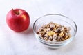 Healthy breakfast with banana, apple and Fresh granola, muesli in bowl on textile background. Top view. Royalty Free Stock Photo