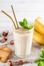 Healthy breakfast. Banana smoothie with cookies in a glass, fruits and cookies made of sunflower seeds, sesame and honey Royalty Free Stock Photo