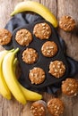 Healthy breakfast banana walnut muffins close-up in a baking dish. Vertical top view Royalty Free Stock Photo