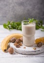 Healthy breakfast. Banana walnuts smoothie with collagen, coconut milk in glass jar Royalty Free Stock Photo