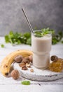 Healthy breakfast. Banana walnuts smoothie with collagen, coconut milk in glass jar Royalty Free Stock Photo
