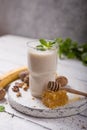 Healthy breakfast. Banana walnuts smoothie with collagen, coconut milk in glass jar Royalty Free Stock Photo