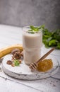 Healthy breakfast. Banana walnuts smoothie with collagen, coconut milk in glass jar Royalty Free Stock Photo