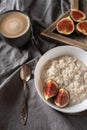 Healthy breakfast in bed. Coffee, porridge with figs, on a rustic wooden board. Clean food, alkaline diet,