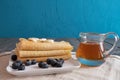 Healthy breakfast, blueberries, freshly baked pancakes on the plate, honey in a jug next to it