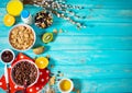 Healthy breakfast with bowl of cereal, orange juice, granola, milk, jam and fruits on blue wood background. Balanced diet. Royalty Free Stock Photo