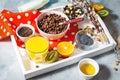Healthy breakfast with bowl of cereal, orange juice, granola, milk, jam and fruits on tray on concrete background. Royalty Free Stock Photo