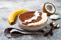 Healthy breakfast bowl. Chocolate banana smoothie bowl with coconut flakes, granola, banana slices Royalty Free Stock Photo