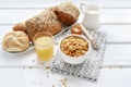 Healthy breakfast: bowl of corn flakes, jug of milk, sliced fruits, jar of honey Royalty Free Stock Photo