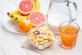 Healthy breakfast. bowl of cornflakes, fruit, fresh juice, milk Royalty Free Stock Photo