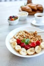 Healthy breakfast bowl, fresh granola, muesli with yogurt fruits and coffee, strawberry, banana on white table, Top view, Copy spa Royalty Free Stock Photo