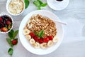 Healthy breakfast bowl, fresh granola, muesli with yogurt fruits and coffee, strawberry, banana on white table, Copy space. Royalty Free Stock Photo