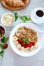 Healthy breakfast bowl, fresh granola, muesli with yogurt fruits and coffee, strawberry, banana on white table, Top view, Copy spa Royalty Free Stock Photo