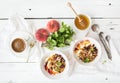 Healthy breakfast. Bowl of oat granola with yogurt, fresh fruit, mint and honey Royalty Free Stock Photo