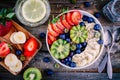 Breakfast bowl: oatmeal with banana, kiwi, strawberry, blueberries and chia seeds