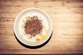 Healthy breakfast - bowl of porridge with cinnamon, maple syrup and linseed