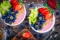 Healthy breakfast bowl: raspberry smoothies with granola, blueberries, strawberries and carambola Royalty Free Stock Photo