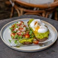 Healthy breakfast with bread toast and poached egg with green salad, red tomato and smashed avocado Royalty Free Stock Photo