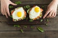 Healthy breakfast. Bread toasts with cheese, fried eggs, fish and fresh vegetables over wooden background, top view. Diet, weight Royalty Free Stock Photo