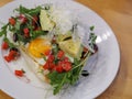 Healthy breakfast brunt egg with some vegetables and avocada on a white plate. Royalty Free Stock Photo