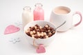 Healthy Breakfast with cereal balls and milk drinks and pink hearts on a light background. Royalty Free Stock Photo