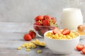 Healthy breakfast - cereal in a white bowl with strawberries, milk and honey Royalty Free Stock Photo