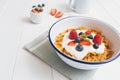 Healthy breakfast with cereals and berries in an enamel bowl Royalty Free Stock Photo