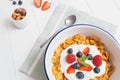 Healthy breakfast with cereals and berries in an enamel bowl Royalty Free Stock Photo