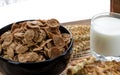 A healthy breakfast. Cereals are at the black plate on the wood background