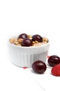 Healthy Breakfast with Cereals, Yogurt, Cherries and Raspberries in White Bowl Royalty Free Stock Photo