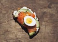 Healthy breakfast. Sandwiches of whole grain bread, scream cream cheese, egg, avocado and salmon fish on a wooden background Royalty Free Stock Photo