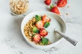 Healthy breakfast concept. Bowl with granola, yogurt and berries on white marble background Royalty Free Stock Photo