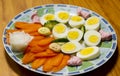 Healthy breakfast concept, closeup of eggs, carrot, radish, cucumber, diet meal Royalty Free Stock Photo