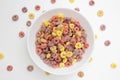 Healthy breakfast concept, Colorful ring cereal in bowl and falling on white background Royalty Free Stock Photo