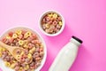Healthy breakfast concept, Colorful ring cereals in large bowl and mini bowl with milk in bottle Royalty Free Stock Photo