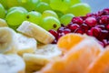 Healthy Breakfast Concept. Fresh fruits on the breakfast table. Close up of Grapes, banana, oranges, pomegranate.