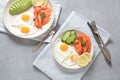 Healthy breakfast concept, fried eggs, avocado and smoked salmon